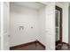 A spacious laundry room area with dark hardwood floors and white walls at 3331 Eastwood Dr, Charlotte, NC 28205