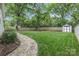Expansive backyard with lush green grass, a stone walkway, and privacy fence at 3809 Topsfield Rd, Charlotte, NC 28211