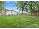 Wide shot of the spacious, green backyard with a fence, storage shed and back deck at 3809 Topsfield Rd, Charlotte, NC 28211
