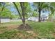 Large backyard featuring mature trees, a storage shed, and a patio area at 3809 Topsfield Rd, Charlotte, NC 28211