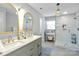 Bright bathroom features double vanity, glass shower with a rain shower head, and modern lighting at 3809 Topsfield Rd, Charlotte, NC 28211