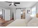Bright bedroom with a king-sized bed, hardwood floors, barn door leading to bathroom with glass shower at 3809 Topsfield Rd, Charlotte, NC 28211