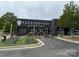 Vaulted Oak Brewing exterior featuring dark modern facade, visible patio, and manicured landscaping at 3809 Topsfield Rd, Charlotte, NC 28211