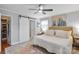 Light-filled main bedroom with neutral tones, ceiling fan, and a barn door to the closet at 3809 Topsfield Rd, Charlotte, NC 28211