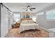 Neutral main bedroom features ceiling fan, hardwood floors, and natural light at 3809 Topsfield Rd, Charlotte, NC 28211