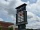 Shopping center sign featuring various retailers and dining options at 3809 Topsfield Rd, Charlotte, NC 28211