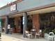Common Market storefront featuring outdoor seating, red brick accents, and ample natural light at 3809 Topsfield Rd, Charlotte, NC 28211