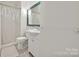 Bathroom with white vanity, large mirror, and shower with clear curtain at 402 W 8Th St, Charlotte, NC 28202