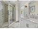 Bathroom featuring tiled shower with glass door, white vanity and charming stained glass window at 402 W 8Th St, Charlotte, NC 28202