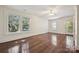 Spacious bedroom features hardwood flooring, ceiling fan, large windows, and private entrance at 402 W 8Th St, Charlotte, NC 28202