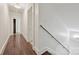 Long hallway featuring hardwood flooring, white walls and trim, and access to rooms at 402 W 8Th St, Charlotte, NC 28202