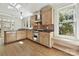 Well-lit kitchen with modern stainless steel appliances, wood floors, and large windows offering natural light at 402 W 8Th St, Charlotte, NC 28202