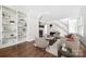 Bright living room featuring a fireplace, built-in shelves, hardwood floors and a staircase at 402 W 8Th St, Charlotte, NC 28202