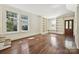Bright living room featuring large windows, hardwood floors, and built-in bookshelves at 402 W 8Th St, Charlotte, NC 28202