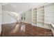 Spacious living room boasting hardwood floors, built-in shelving, and a staircase at 402 W 8Th St, Charlotte, NC 28202