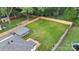 Aerial view showcasing the property layout with large green yard, deck, and parking at 418 Link St, Fort Mill, SC 29715