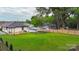 A spacious green yard with wood fence, deck, and car port on the property at 418 Link St, Fort Mill, SC 29715