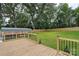 A wood deck and backyard featuring a newly installed wood fence and covered parking at 418 Link St, Fort Mill, SC 29715