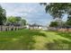 A spacious green backyard with a wooden fence, deck, and car port at 418 Link St, Fort Mill, SC 29715