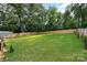 A spacious, fenced backyard with green grass, perfect for outdoor activities at 418 Link St, Fort Mill, SC 29715