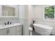 Modern bathroom with a new vanity, soaking tub, marble accent wall, and window with natural light at 418 Link St, Fort Mill, SC 29715