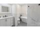 Luxurious bathroom featuring a sleek vanity, soaking tub, marble accents, and a window at 418 Link St, Fort Mill, SC 29715
