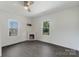 Cozy bedroom with a ceiling fan, fireplace, and hardwood floors offering a comfortable retreat at 418 Link St, Fort Mill, SC 29715