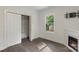 Well lit bedroom with dark floors, a closet with bi-fold doors, and a fireplace at 418 Link St, Fort Mill, SC 29715