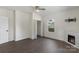 Bright bedroom with dark wood floors, ceiling fan, fireplace, closet, and lots of natural light at 418 Link St, Fort Mill, SC 29715