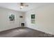 Cozy bedroom with dark wood floors, a fireplace, and two large windows with views of the outdoors at 418 Link St, Fort Mill, SC 29715