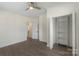 Light and airy bedroom with dark wood floors, a large closet with shelving, and neutral paint at 418 Link St, Fort Mill, SC 29715