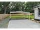 View of carport with concrete slab and a wood fence; a functional addition to the property at 418 Link St, Fort Mill, SC 29715