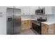 Well-equipped kitchen boasts stainless-steel appliances, ample white cabinets, and stylish granite countertops at 418 Link St, Fort Mill, SC 29715