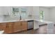Modern kitchen featuring stainless-steel appliances, white cabinets, and a sleek countertop breakfast bar with sink at 418 Link St, Fort Mill, SC 29715
