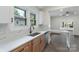 Updated kitchen includes stainless-steel dishwasher and sink, modern countertops, and wood cabinets at 418 Link St, Fort Mill, SC 29715