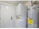 Convenient laundry area featuring a stacked washer/dryer unit and an adjacent water heater at 418 Link St, Fort Mill, SC 29715