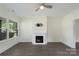 Living room with modern fireplace, ceiling fan, and hardwood flooring at 418 Link St, Fort Mill, SC 29715
