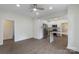 Open-concept living room with modern flooring, ceiling fan, and access to the updated kitchen with stainless appliances at 418 Link St, Fort Mill, SC 29715