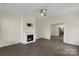 Living room with modern fireplace, ceiling fan, and hardwood flooring at 418 Link St, Fort Mill, SC 29715