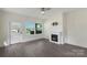 Bright living room with fireplace, hardwood flooring, and ample natural light at 418 Link St, Fort Mill, SC 29715