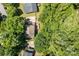 Aerial shot reveals a home nestled in a forest surrounded by lush, mature trees at 4232 Saint Audrey Pl, Charlotte, NC 28269