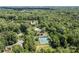 Aerial view featuring the community amenities, including a pool and tennis courts, all surrounded by lush greenery at 4232 Saint Audrey Pl, Charlotte, NC 28269