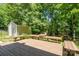 Spacious backyard deck with seating and adjacent storage shed and playground, perfect for outdoor living and entertaining at 4232 Saint Audrey Pl, Charlotte, NC 28269