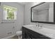 Updated bathroom featuring a stylish vanity, modern fixtures, and a window at 4232 Saint Audrey Pl, Charlotte, NC 28269