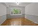 Bedroom with hardwood flooring and a large bay window, providing ample natural light at 4232 Saint Audrey Pl, Charlotte, NC 28269