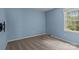 Blue painted bedroom with large window, plush carpet, and a wall mounted TV bracket at 4232 Saint Audrey Pl, Charlotte, NC 28269