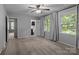 Spacious bedroom with two windows, carpet, ceiling fan, and ensuite bathroom and doorway to another room at 4232 Saint Audrey Pl, Charlotte, NC 28269
