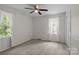 Bright bedroom with two large windows, carpet, ceiling fan, and closet with sliding doors at 4232 Saint Audrey Pl, Charlotte, NC 28269