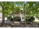 Charming two-story home with red shutters and mature trees in a serene, wooded setting at 4232 Saint Audrey Pl, Charlotte, NC 28269