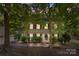 Charming two-story home with red shutters and mature trees in a serene, wooded setting at 4232 Saint Audrey Pl, Charlotte, NC 28269